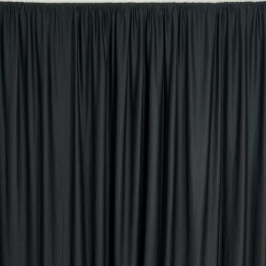 Black shiny event drape with gathered pleats hanging from a rod